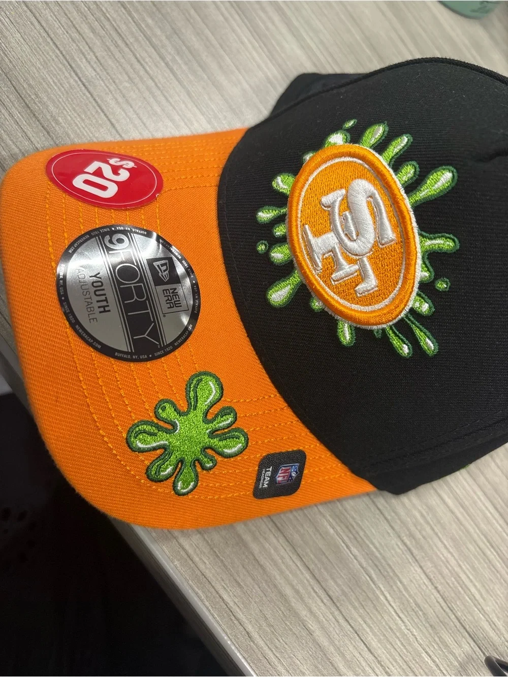 New Era Kids Orange and Black Baseball Cap with Green Embroidery